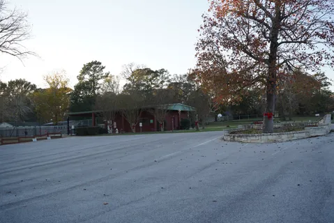 a front view of a house with a yard and tree s