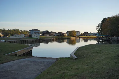 a view of a lake with a yard and a large window