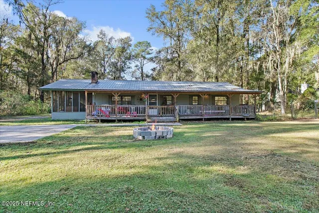 a front view of a house with swimming pool having outdoor seating