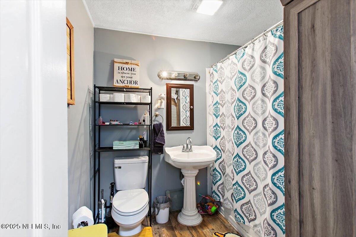 45077 Clemmons Road Callahan, FL 32011 - Photo 11 of 20 a bathroom with a toilet sink and mirror