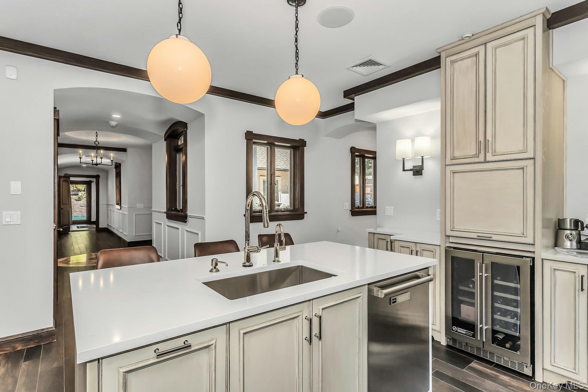 91 Crescent Beach Road Glen Cove, NY 11542 - Photo 11 of 38 a kitchen with stainless steel appliances granite countertop a sink a chandelier and a refrigerator