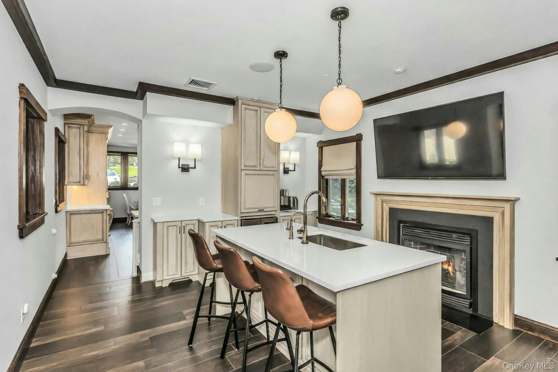 91 Crescent Beach Road Glen Cove, NY 11542 - Photo 12 of 38 a dining room with wooden floor a chandelier a wooden table and chairs