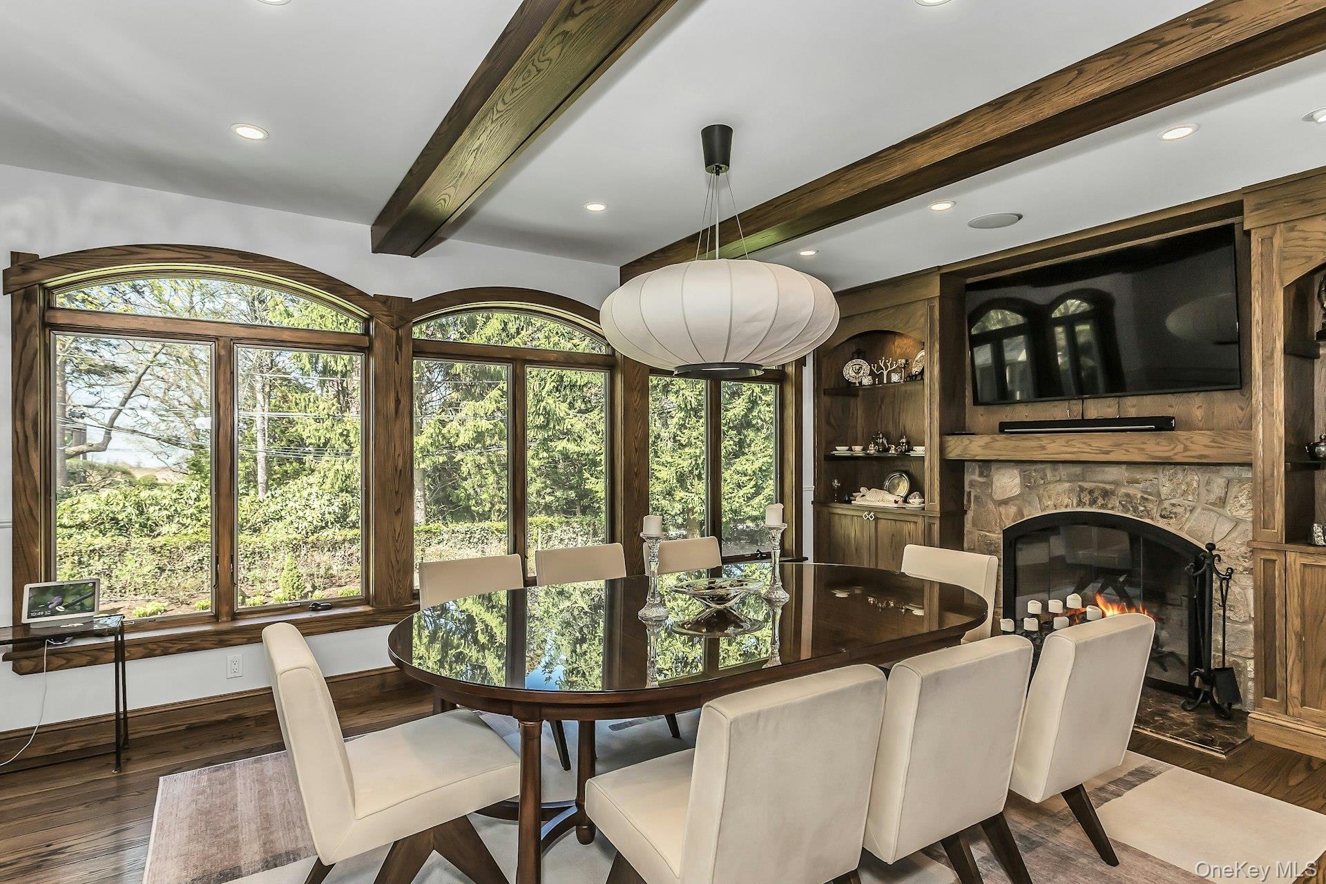 91 Crescent Beach Road Glen Cove, NY 11542 - Photo 15 of 38 a dining room with furniture a chandelier and wooden floor