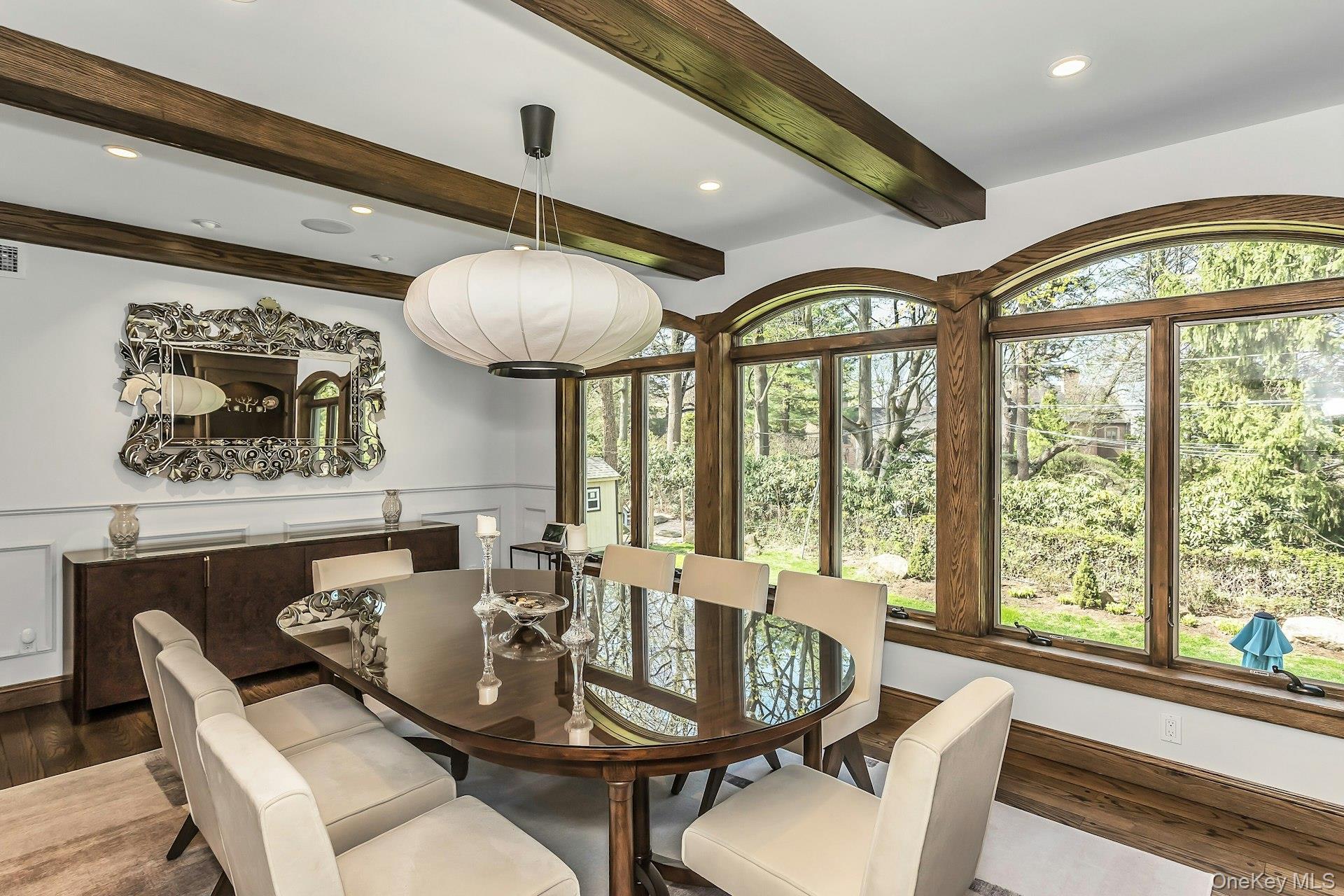 91 Crescent Beach Road Glen Cove, NY 11542 - Photo 16 of 38 a view of a dining room with furniture wooden floor and chandelier