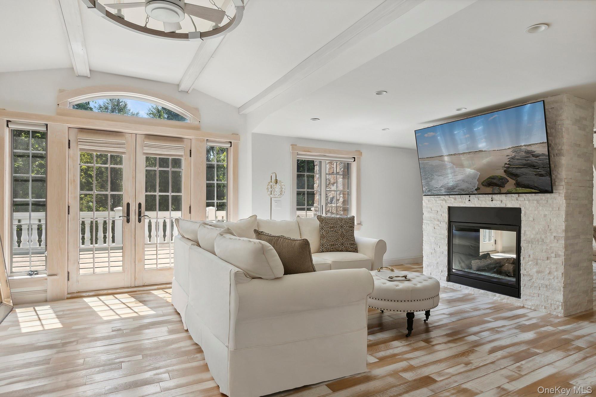 91 Crescent Beach Road Glen Cove, NY 11542 - Photo 22 of 38 a living room with furniture and a fireplace