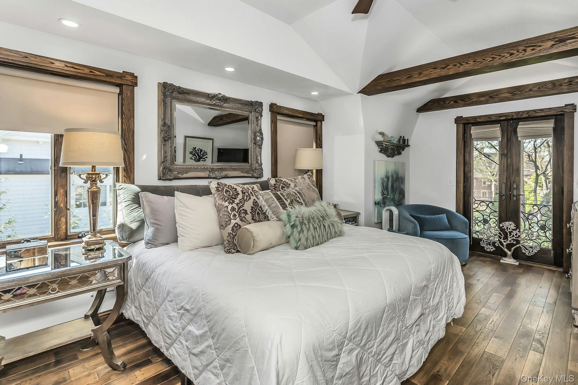 91 Crescent Beach Road Glen Cove, NY 11542 - Photo 25 of 38 a bedroom with a large bed and windows