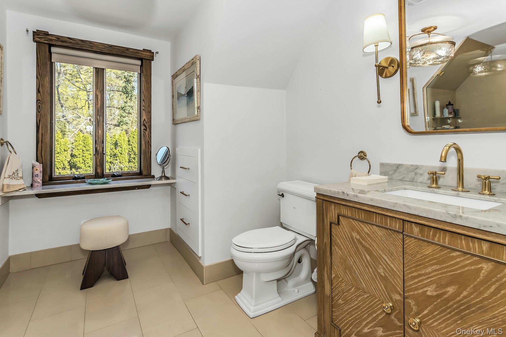 91 Crescent Beach Road Glen Cove, NY 11542 - Photo 26 of 38 a bathroom with a toilet sink and mirror