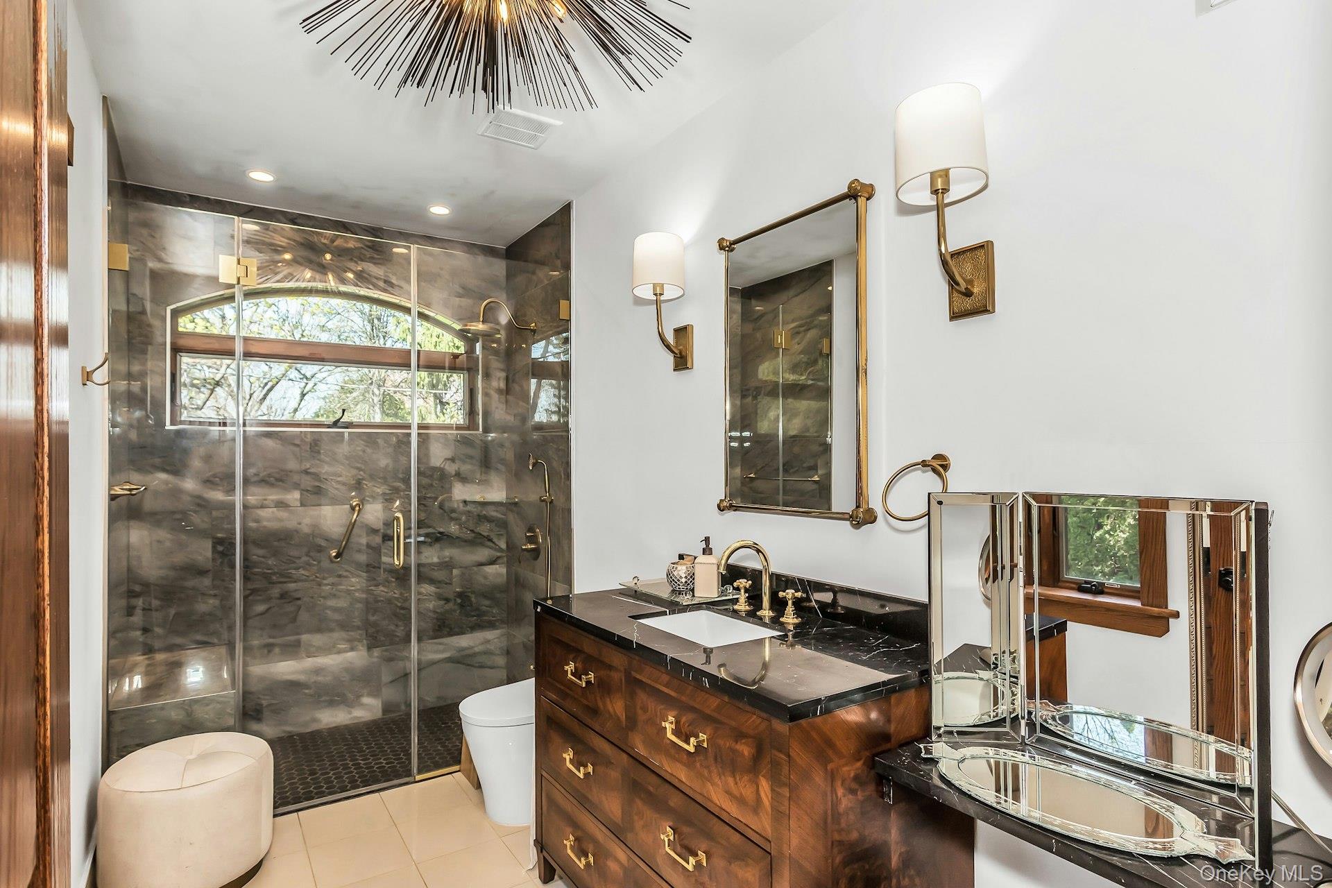 91 Crescent Beach Road Glen Cove, NY 11542 - Photo 29 of 38 a bathroom with a granite countertop sink a toilet a mirror and shower