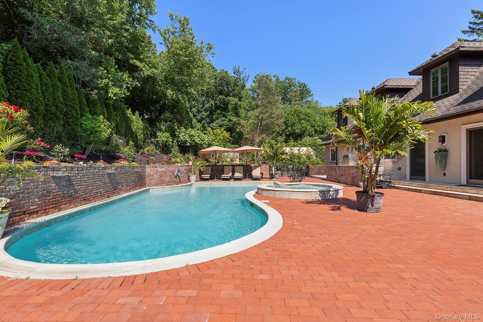 91 Crescent Beach Road Glen Cove, NY 11542 - Photo 3 of 38 a view of a swimming pool with an outdoor seating