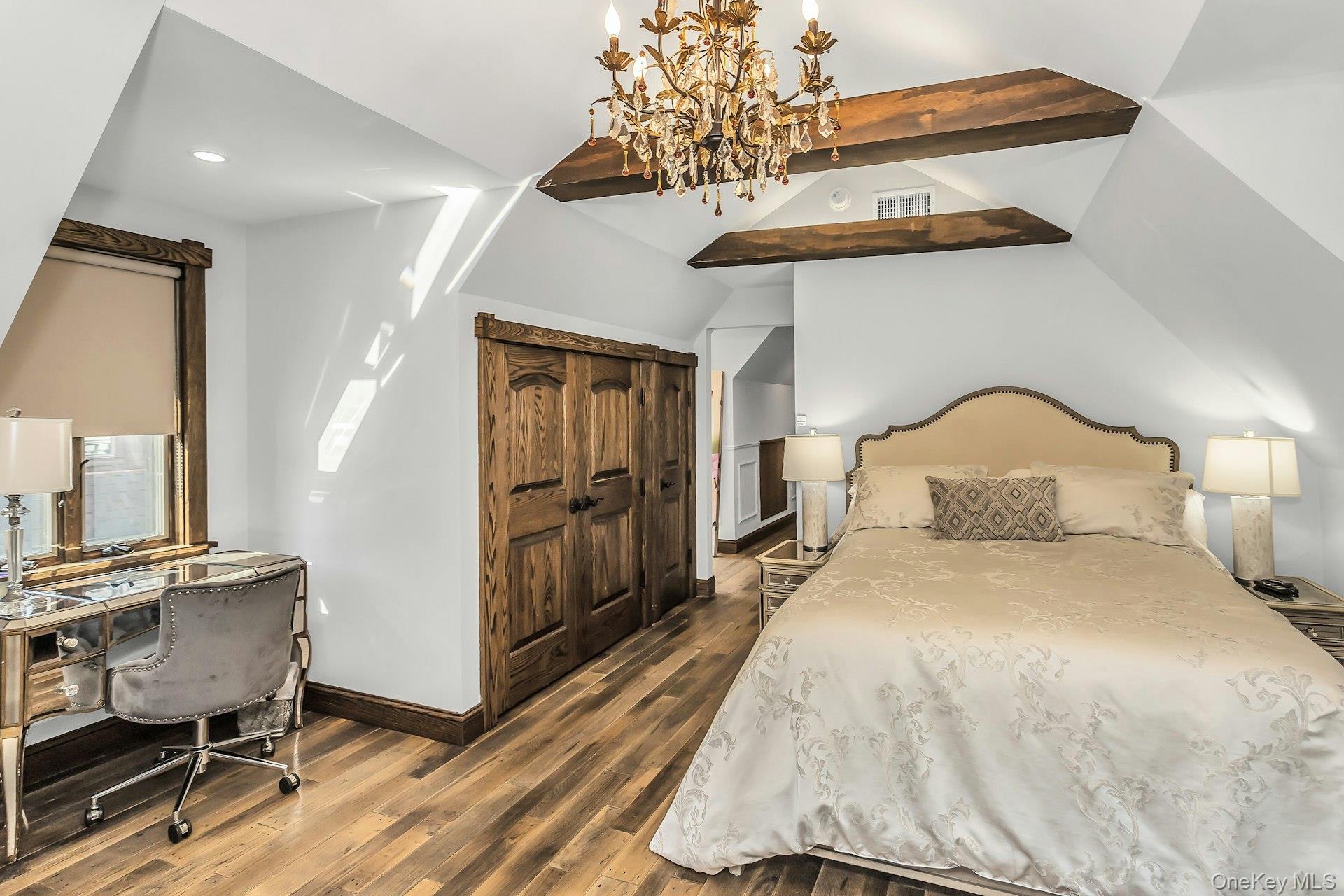 91 Crescent Beach Road Glen Cove, NY 11542 - Photo 31 of 38 a bedroom with a bed and a chair