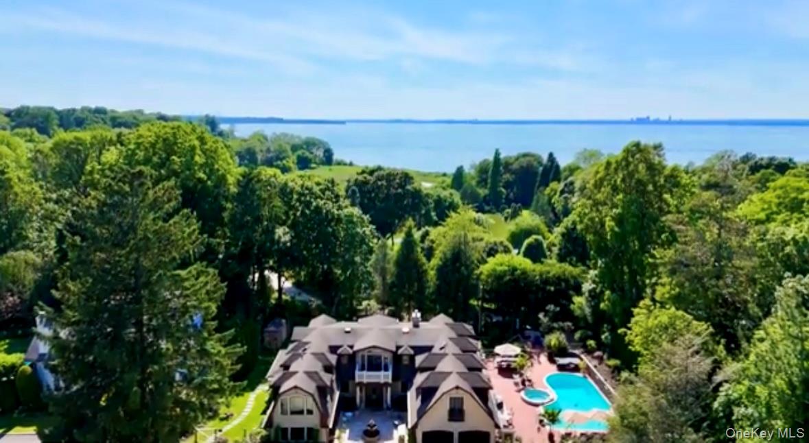 91 Crescent Beach Road Glen Cove, NY 11542 - Photo 34 of 38 an aerial view of a house with yard and outdoor seating