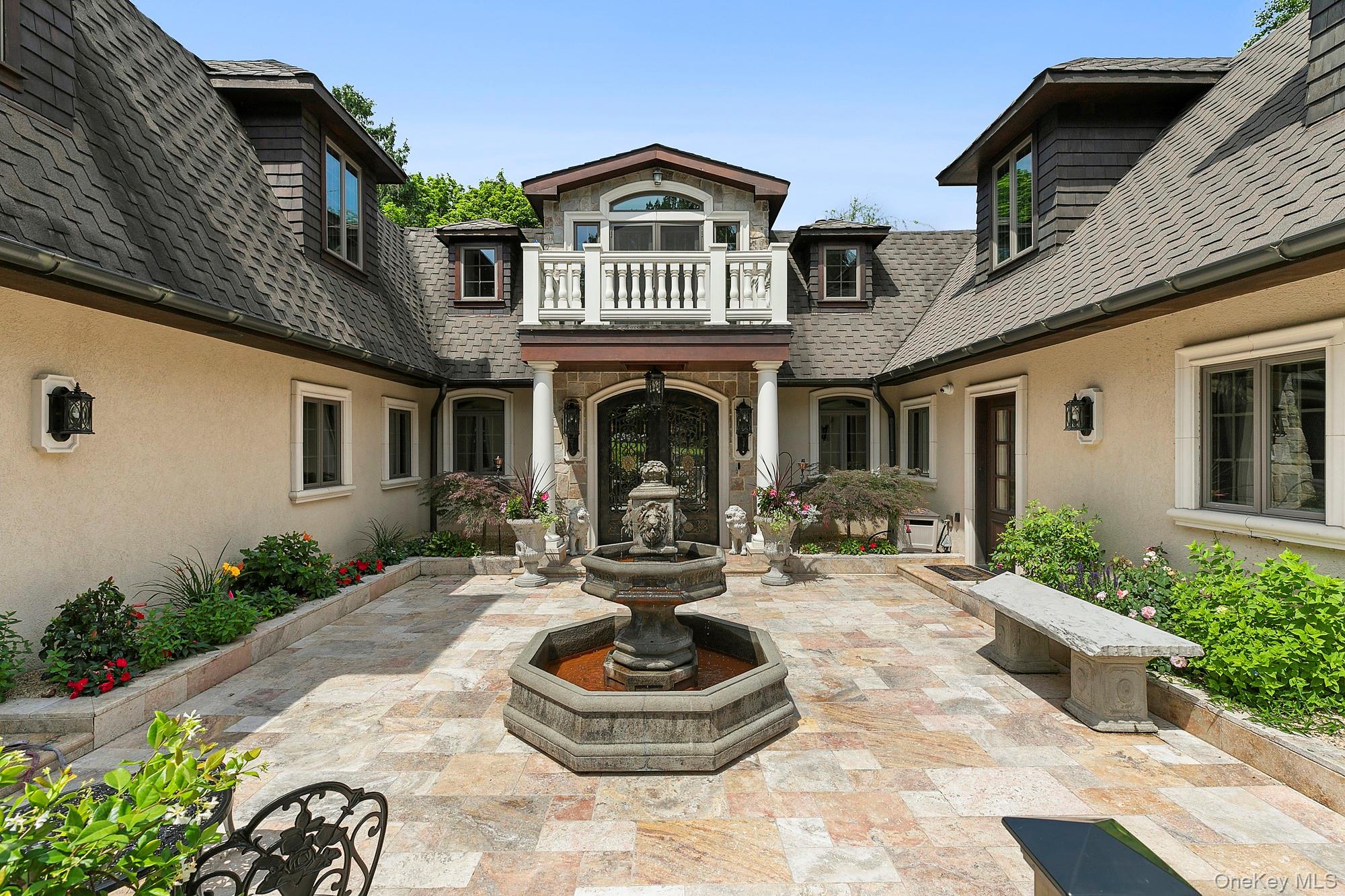 91 Crescent Beach Road Glen Cove, NY 11542 - Photo 5 of 38 a front view of a house with a garden