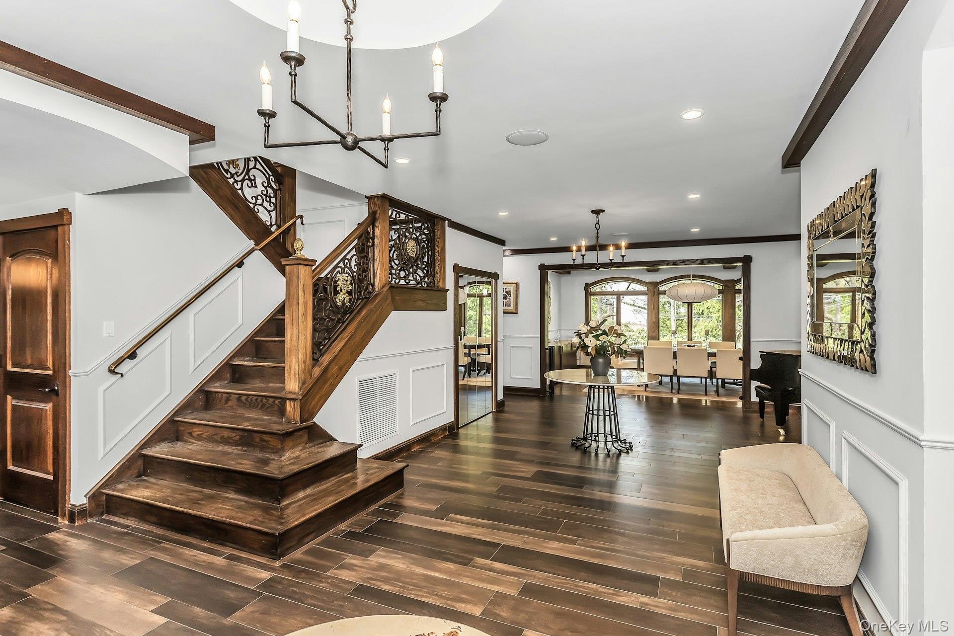 91 Crescent Beach Road Glen Cove, NY 11542 - Photo 8 of 38 a view of dining room with furniture staircase and a ceiling fan
