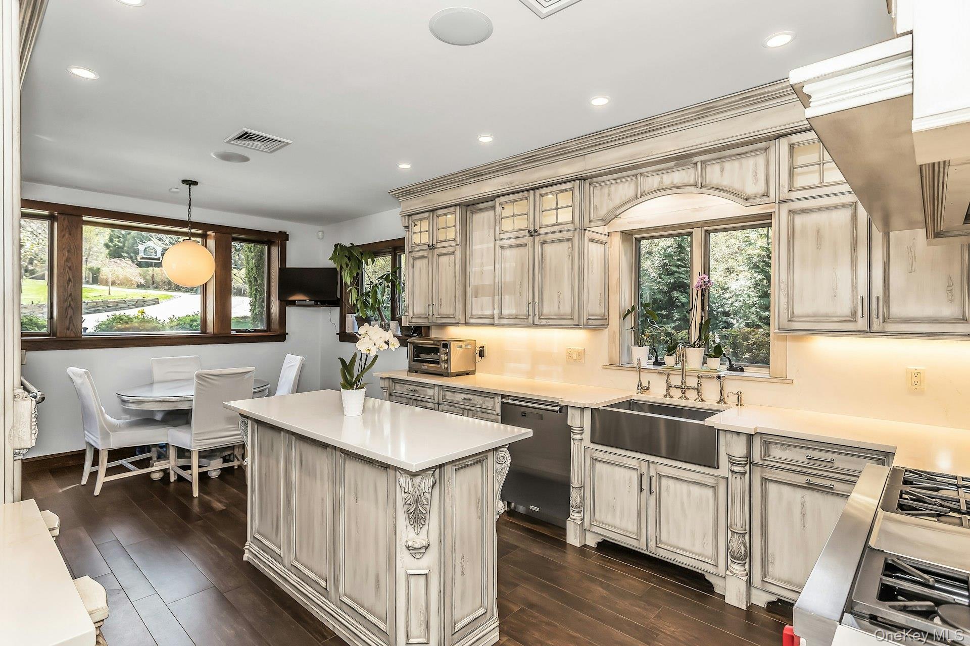 91 Crescent Beach Road Glen Cove, NY 11542 - Photo 9 of 38 a kitchen with sink stove and wooden floor