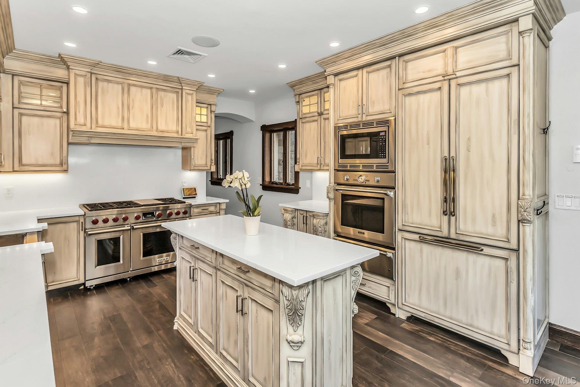 91 Crescent Beach Road Glen Cove, NY 11542 - Photo 10 of 38 a kitchen with a stove a sink and a refrigerator