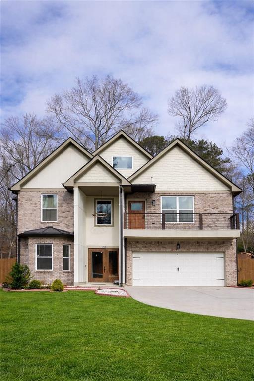 658 Rockbridge Road Northwest Lilburn, GA 30047 - Photo 1 of 61 a front view of a house with a yard and garage
