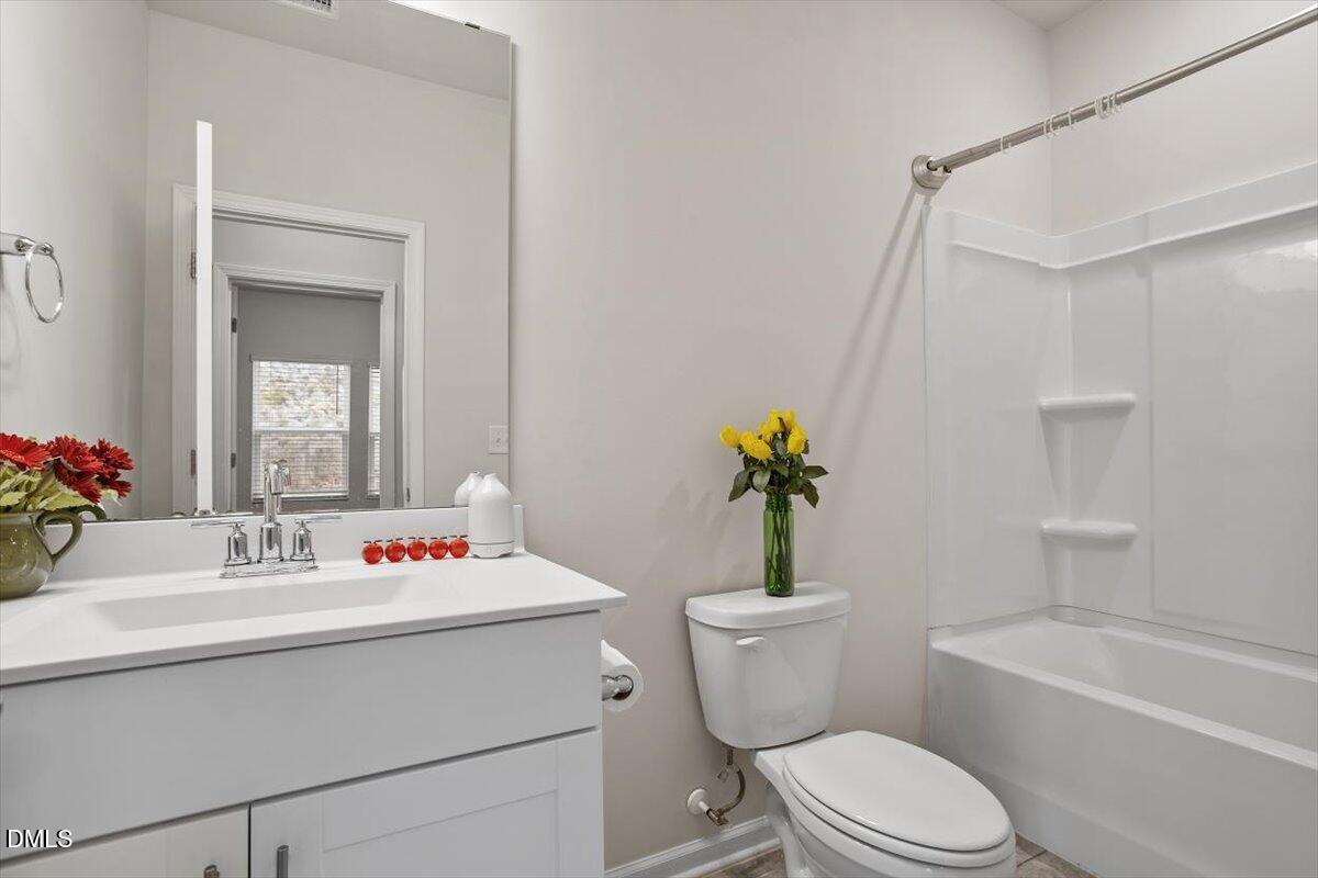 46 Coffee Tree Circle Clayton, NC 27527 - Photo 17 of 36 a bathroom with a sink mirror vanity and toilet