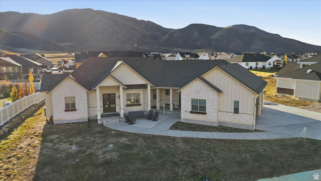 534 East Fish Hatchery Road Mantua, UT 84324 - Photo 76 of 87 View of front of home featuring board and batten siding, stone siding, and covered porch