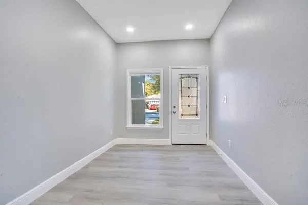 an empty room with windows and closet