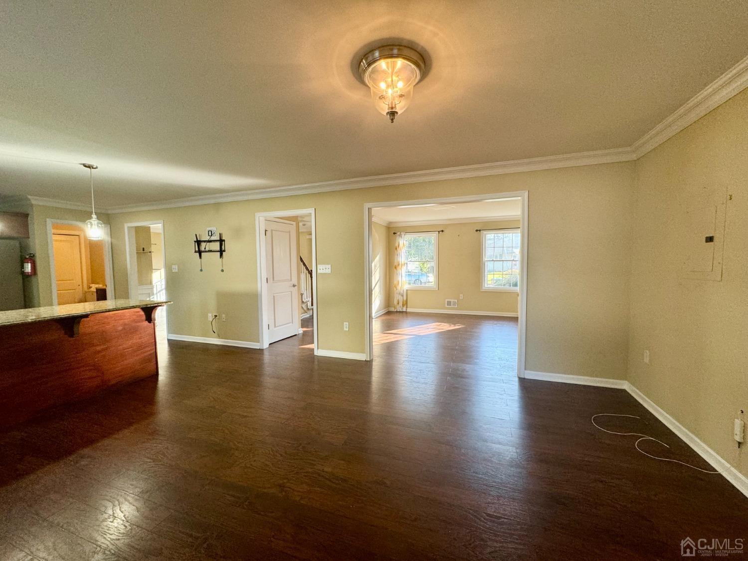 14 Baxter Road Edison, NJ 08817 - Photo 14 of 16 a view of an empty room with wooden floor and a window