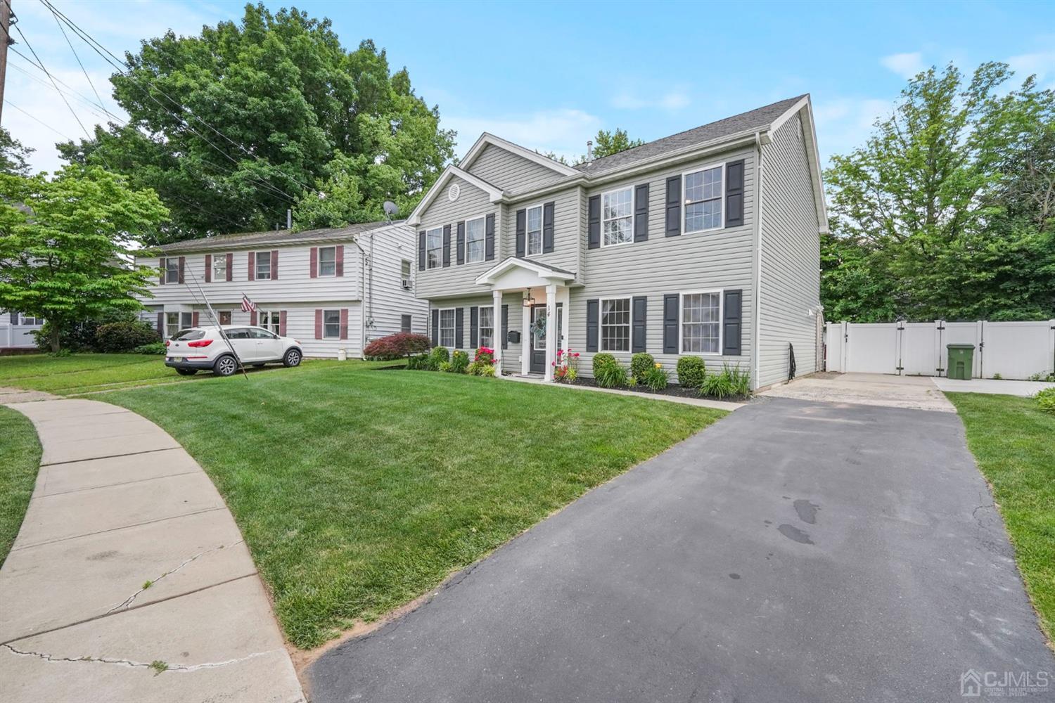 14 Baxter Road Edison, NJ 08817 - Photo 2 of 16 a front view of a house with a yard and trees