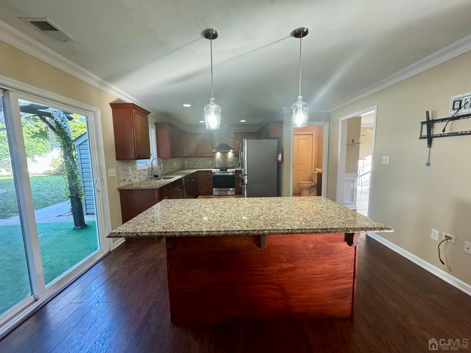 14 Baxter Road Edison, NJ 08817 - Photo 4 of 16 a large kitchen with kitchen island a large counter top space a sink and appliances