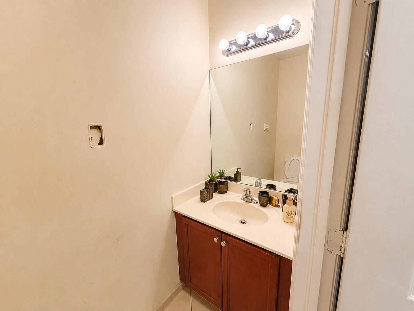 10463 Southwest 228th Terrace Miami, FL 33190 - Photo 7 of 8 a bathroom with a sink and a mirror