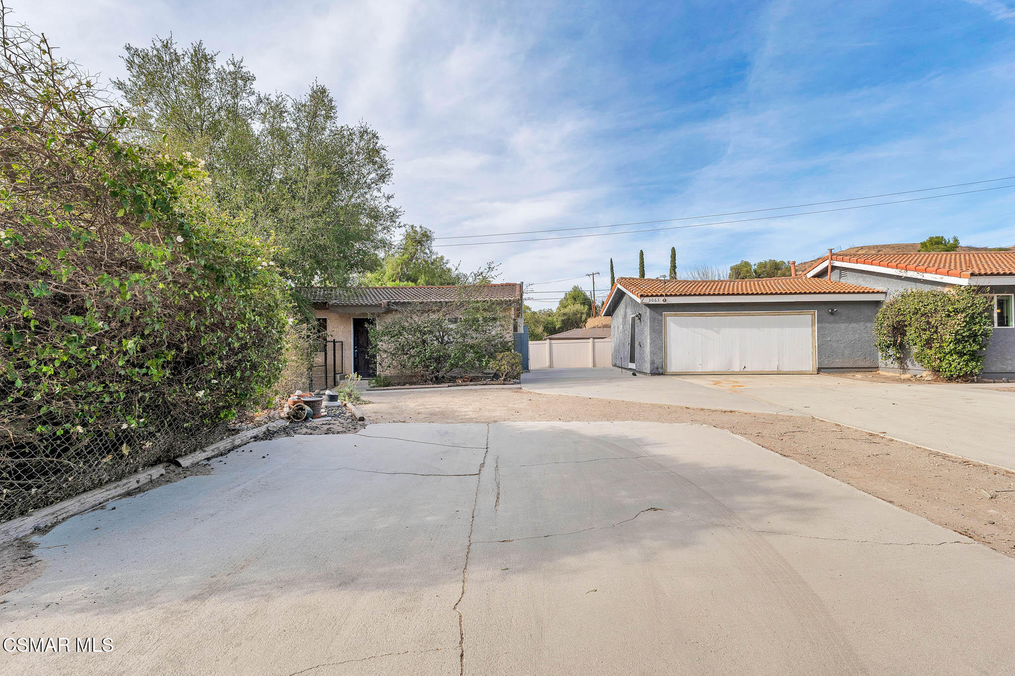 3063 Ditch Road Simi Valley, CA 93063 - Photo 28 of 49 a front view of a house with a yard and a garage
