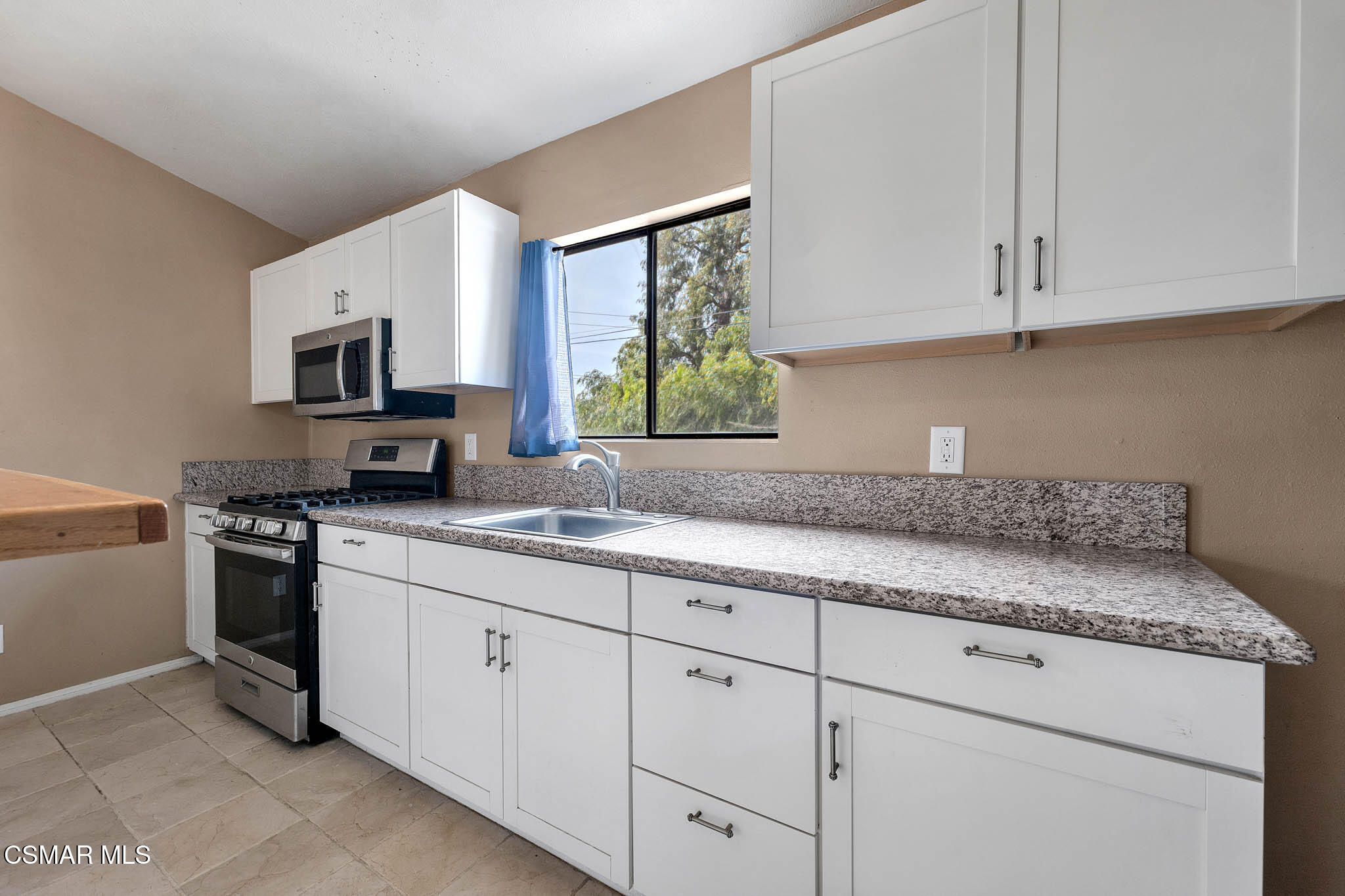 3063 Ditch Road Simi Valley, CA 93063 - Photo 36 of 49 a kitchen with granite countertop white cabinets stainless steel appliances and a sink