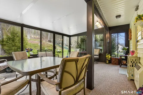 a view of a dining room with furniture and a large window