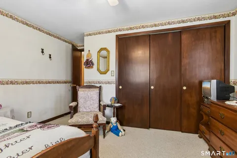 a bedroom with a bed and a mirror