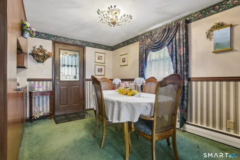 a view of a dining room with furniture window and outside view