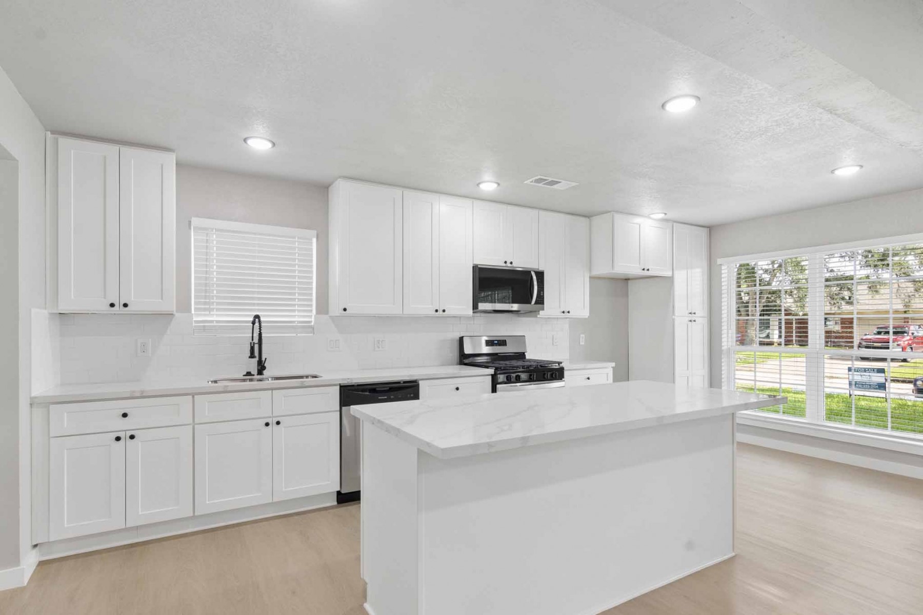 10423 Quiet Hill Road La Porte, TX 77571 - Photo 2 of 27 Fully Renovated Kitchen with Quartz countertops and new appliances (gas stove, dishwasher, and microwave)