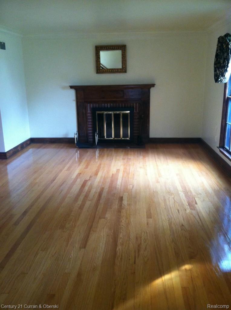14943 Stahelin Road Detroit, MI 48223 - Photo 3 of 16 Living room w/ gorgeous floors & nat. fireplace
