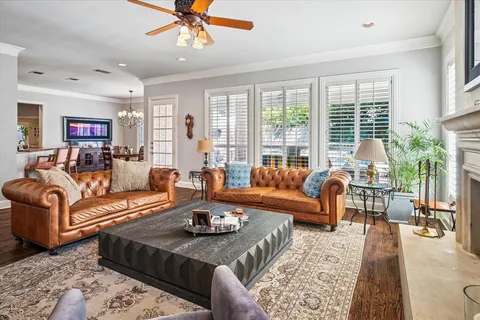 a living room with furniture large window and flat screen tv