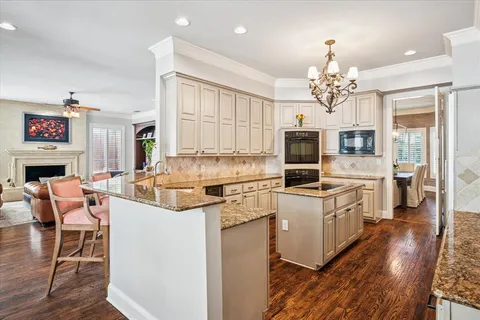 a kitchen with a stove a refrigerator and a fireplace