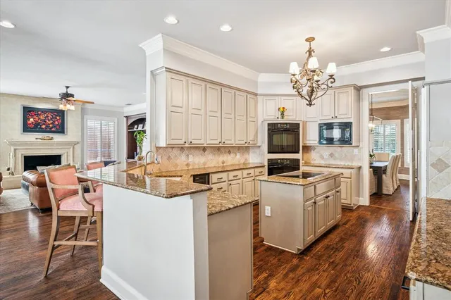 a kitchen with a stove a refrigerator and a fireplace