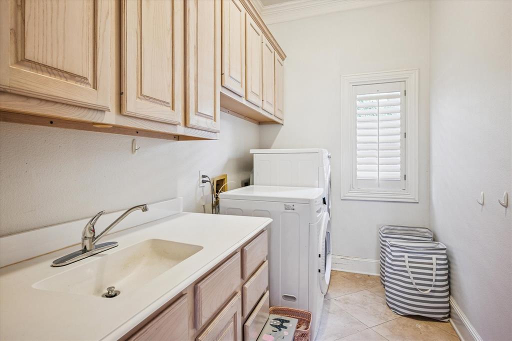 6511 Aberdeen Avenue Dallas, TX 75230 - Photo 19 of 40 a bathroom with a sink and a washing machine