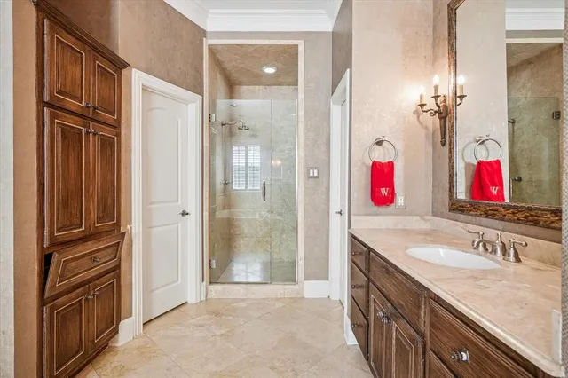 a bathroom with a granite countertop shower sink and mirror