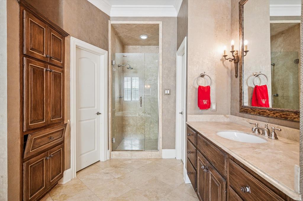 6511 Aberdeen Avenue Dallas, TX 75230 - Photo 23 of 40 a bathroom with a granite countertop shower sink and mirror