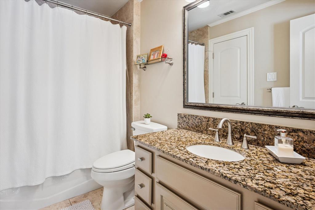 6511 Aberdeen Avenue Dallas, TX 75230 - Photo 28 of 40 a bathroom with a granite countertop sink and a mirror