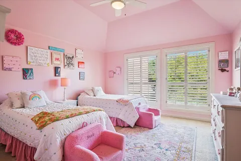a bedroom with bed and a large window