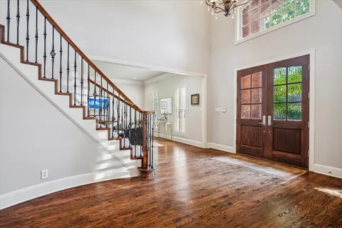 a view of an entryway with wooden floor and door
