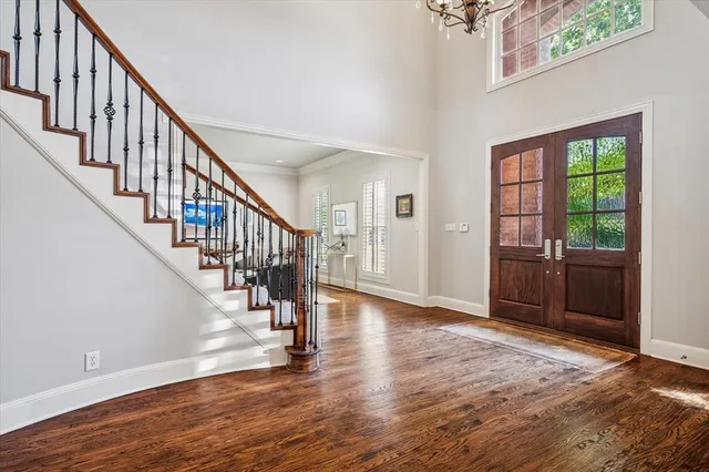 a view of an entryway with wooden floor and door