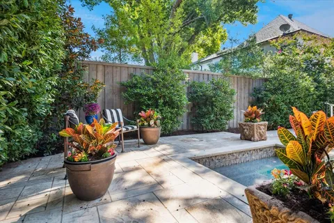 a view of a backyard with sitting area