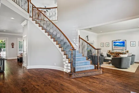 a view of entryway and hall with wooden floor
