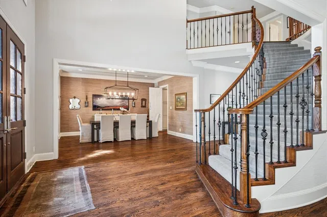 a view of entryway and hall with wooden floor