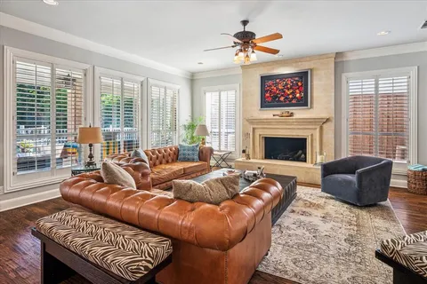 a living room with furniture a large window and a fireplace