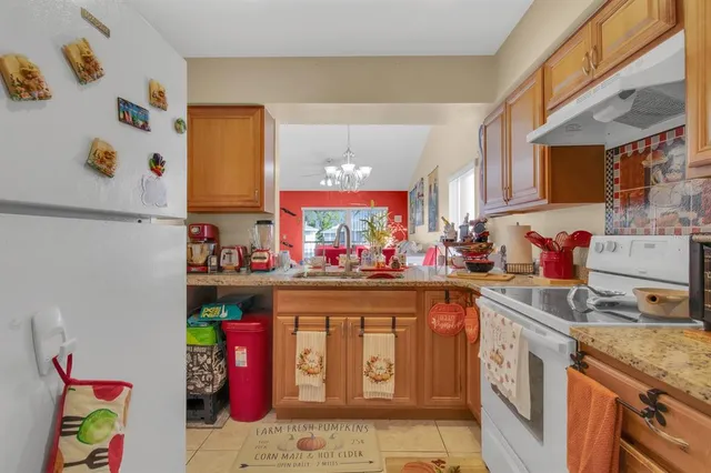 a dining room with furniture a rug and a chandelier