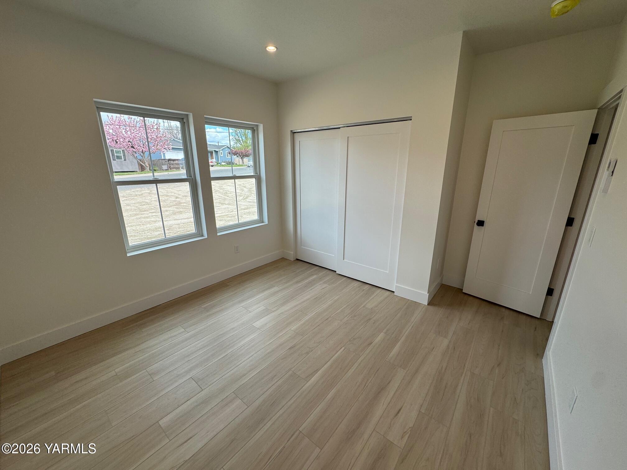 304 6th Street Zillah, WA 98953 - Photo 21 of 29 a view of an empty room with wooden floor and a window